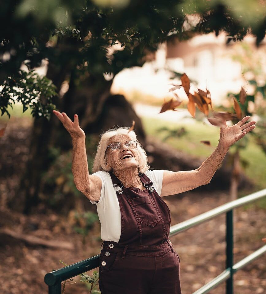 woman wearing brown overalls near brown tree