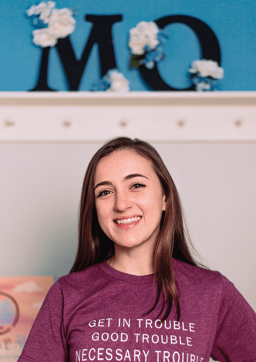 Portrait image of Morgan Rita Barbret, Certified coach, smiling and wearing a shirt that reads "Get in trouble, good trouble, necessary trouble -John Lewis"